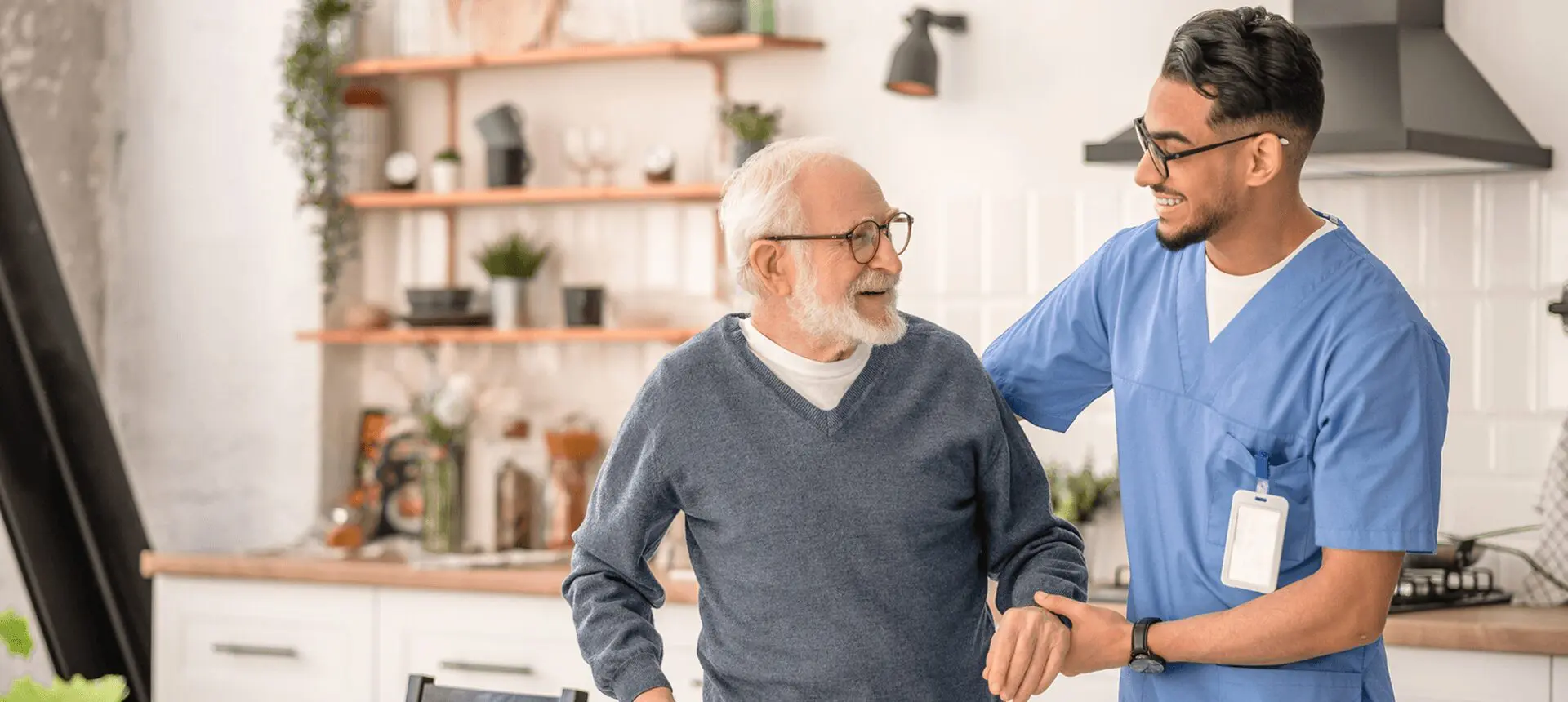 Nurse supporting elderly man with smile