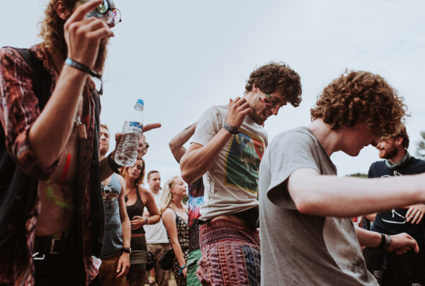 A group of people standing around each other.