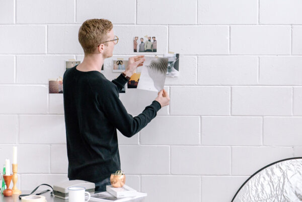 A man is painting on the wall of his home.