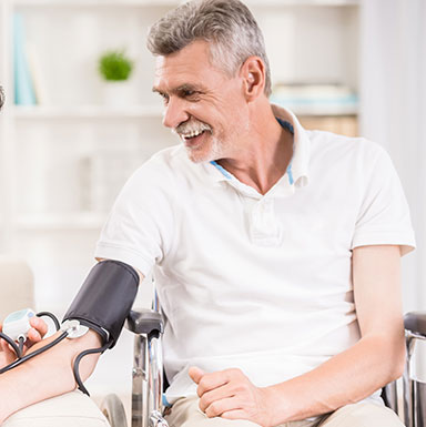 A man is taking his blood pressure at home.