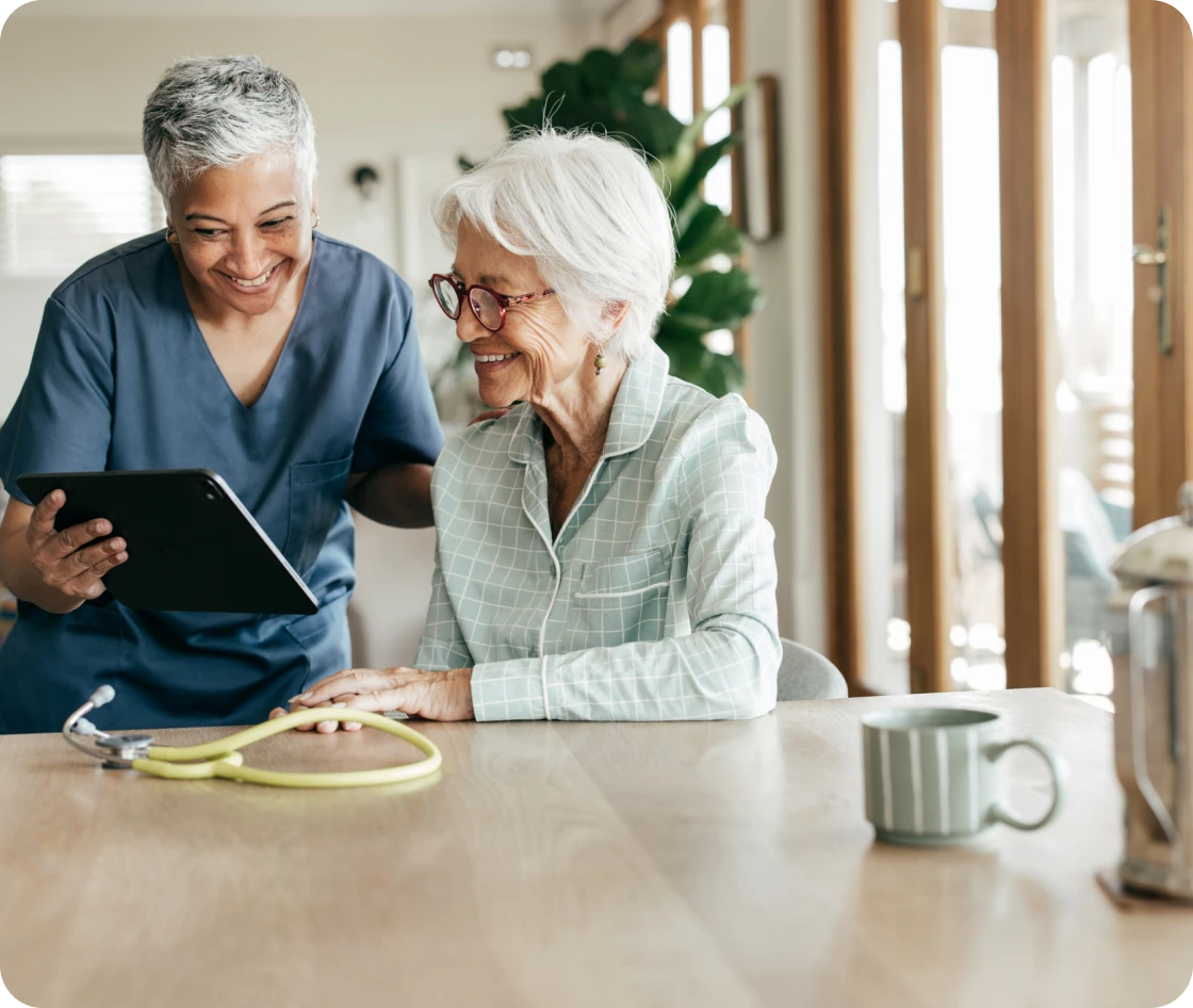 Senior woman smiling with caregiver